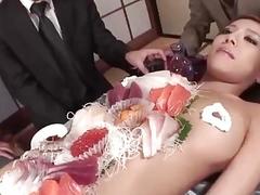 Asian chick is being a food plate for some guys
