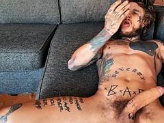 Solo tattooed horny stud masturbates with sex toys